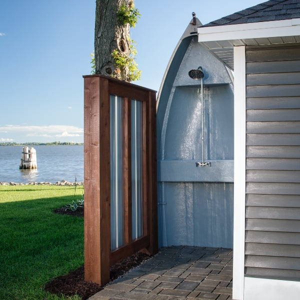 An outdoor shower next to a body of water