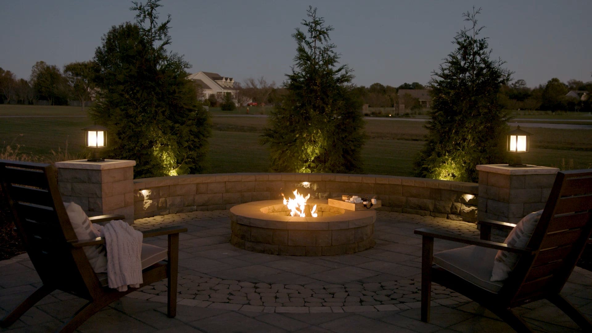 Belgard Rooms living room with firepit in late evening